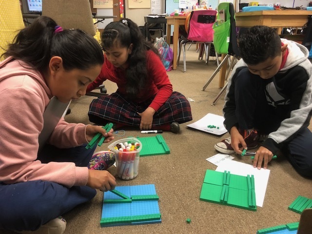 Students working with base 10 blocks